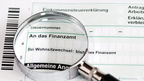 Close up of a german tax form with magnifier - Einkommenssteuererklaerung