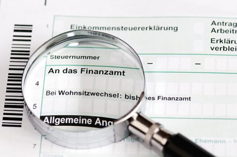 Close up of a german tax form with magnifier - Einkommenssteuererklaerung